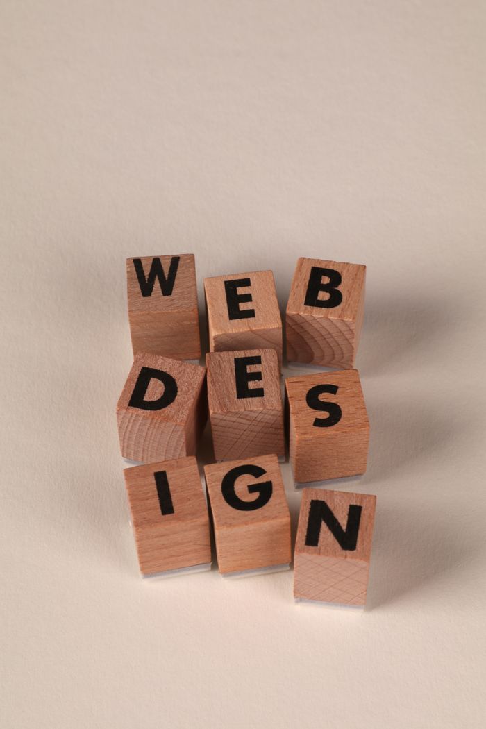 about-02 Wooden blocks arranged to spell Web Design. Perfect for creative, digital content themes.